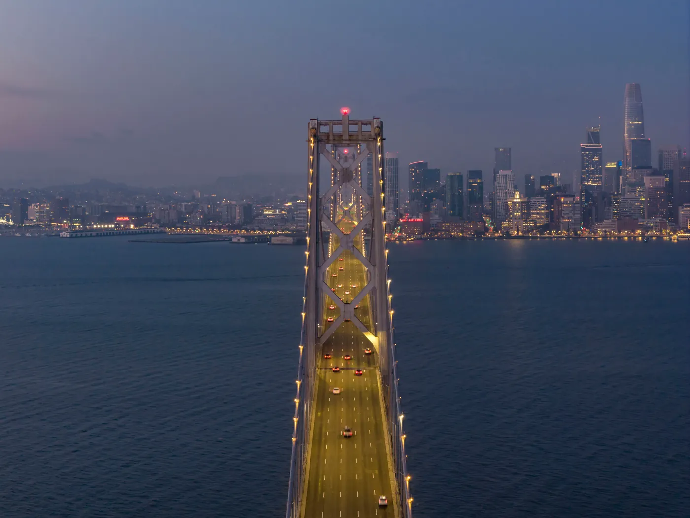 The Bay Bridge at twilight from above with the San Francisco skyline