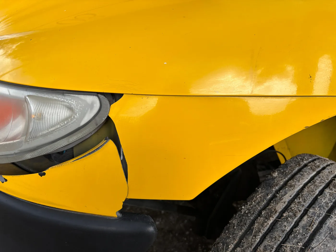 A crumpled yellow fender after a minor collision