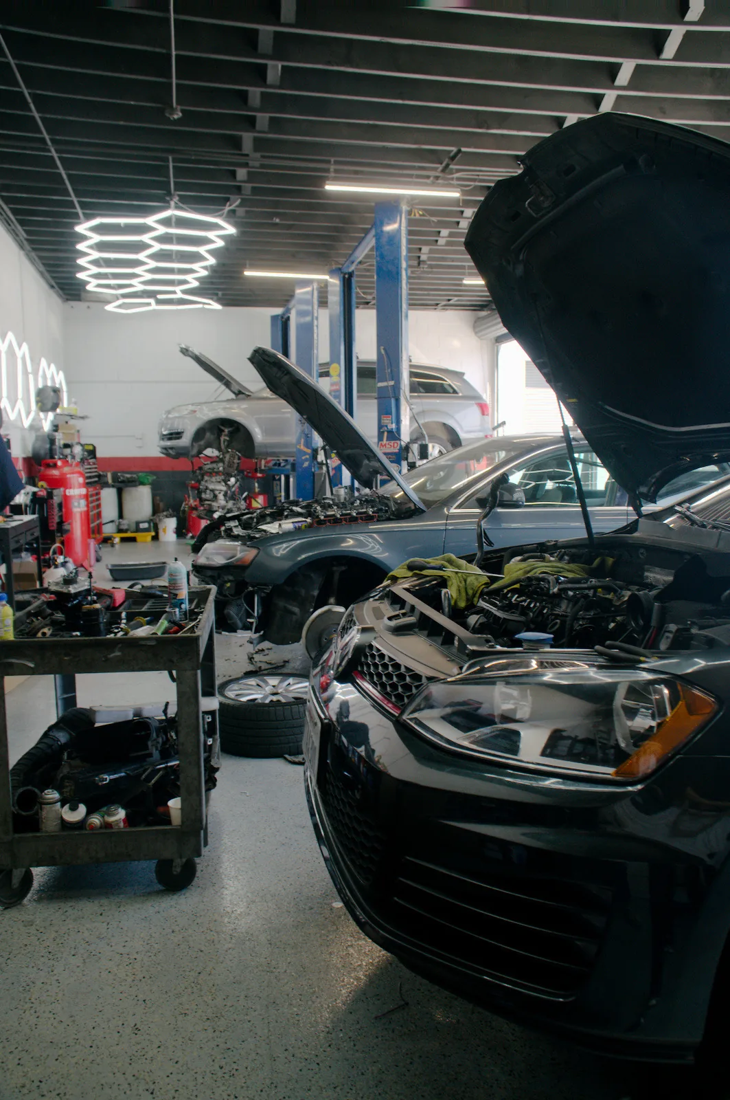 A wide view of the Bay Motors workshop with a car's hood up